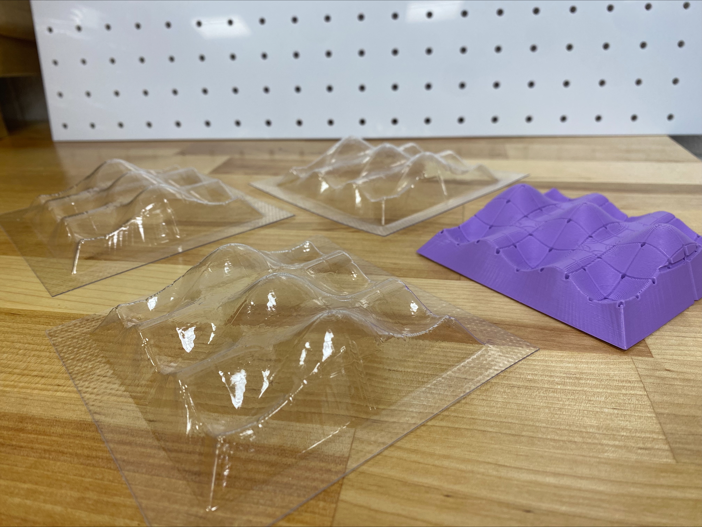 Samples of the plastic molds of 3D surfaces that can be 3D printed at the Friday workshop on 10/3/2025.